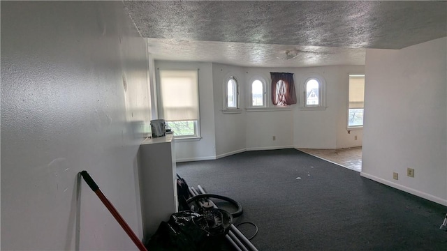 315 Lowell St, East Liberty, PA 15206 - unfurnished living room featuring a textured ceiling, baseboards, and carpet