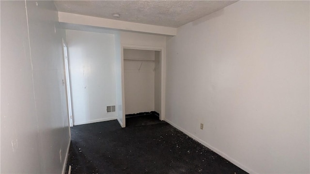 315 Lowell St, East Liberty, PA 15206 - unfurnished bedroom featuring baseboards, a textured ceiling, and a closet