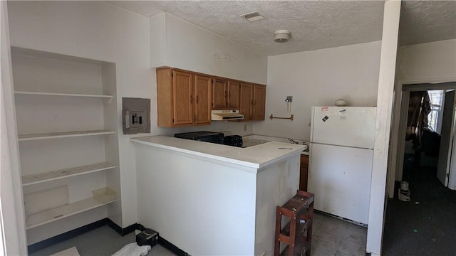 315 Lowell St, East Liberty, PA 15206 - kitchen featuring freestanding refrigerator, electric panel, brown cabinets, light countertops, and a textured ceiling