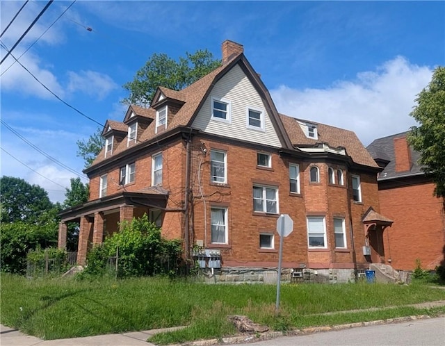 315 Lowell St, East Liberty, PA 15206 - view of side of property featuring brick siding, a chimney, and a gambrel roof