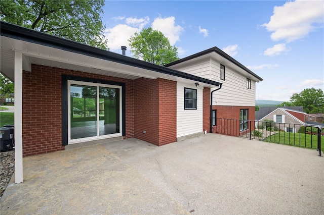 44 Heritage Hills Rd, South Union Twp, PA 15401 - rear view of property featuring brick siding, a patio area, and fence