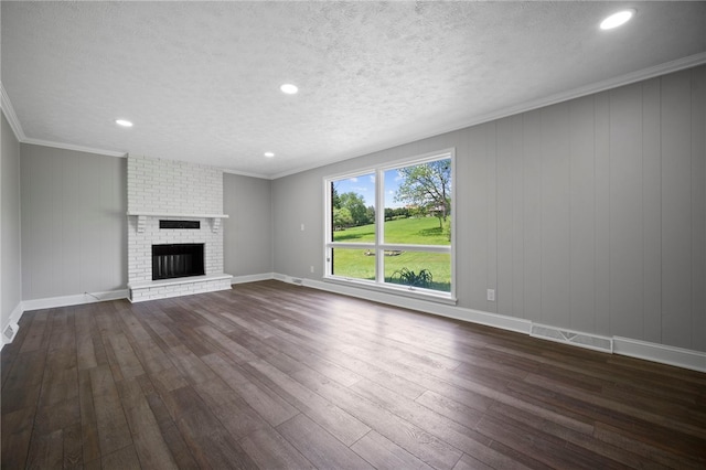 44 Heritage Hills Rd, South Union Twp, PA 15401 - unfurnished living room with dark wood-style floors, a brick fireplace, a textured ceiling, recessed lighting, and baseboards