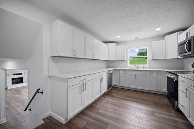 44 Heritage Hills Rd, South Union Twp, PA 15401 - kitchen featuring stainless steel appliances, a textured ceiling, light countertops, dark wood-style floors, and white cabinets