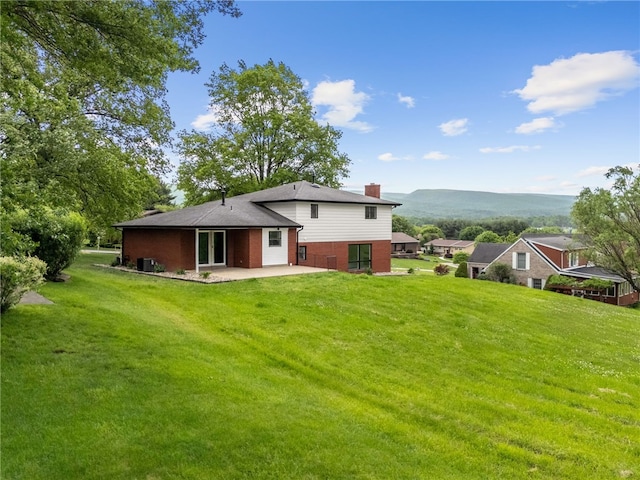 44 Heritage Hills Rd, South Union Twp, PA 15401 - back of house featuring brick siding, a patio area, a chimney, and a yard