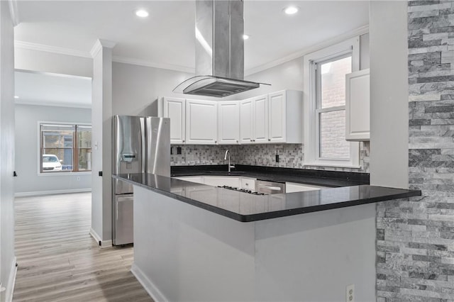 715 Filbert St, Shadyside, PA 15232 - kitchen with stainless steel appliances, island range hood, crown molding, dark countertops, and a sink