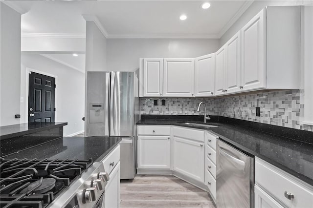 715 Filbert St, Shadyside, PA 15232 - kitchen with appliances with stainless steel finishes, a sink, white cabinets, decorative backsplash, and dark stone counters