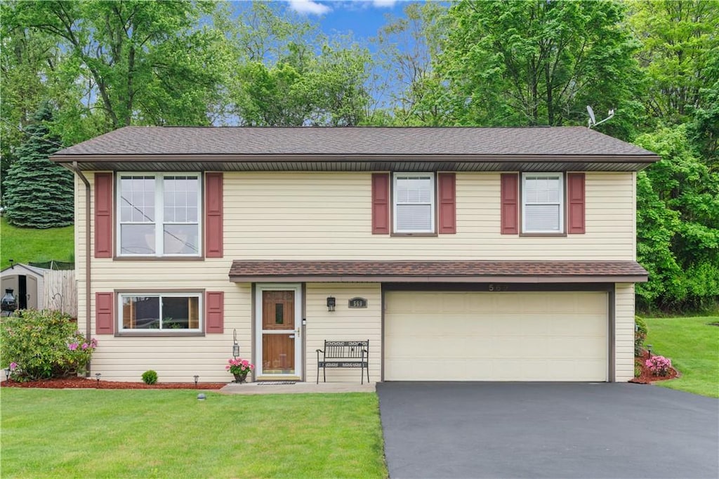 569 Butterfield Dr, North Huntingdon, PA 15642 - view of front of property featuring an attached garage, asphalt driveway, a front yard, and a shingled roof