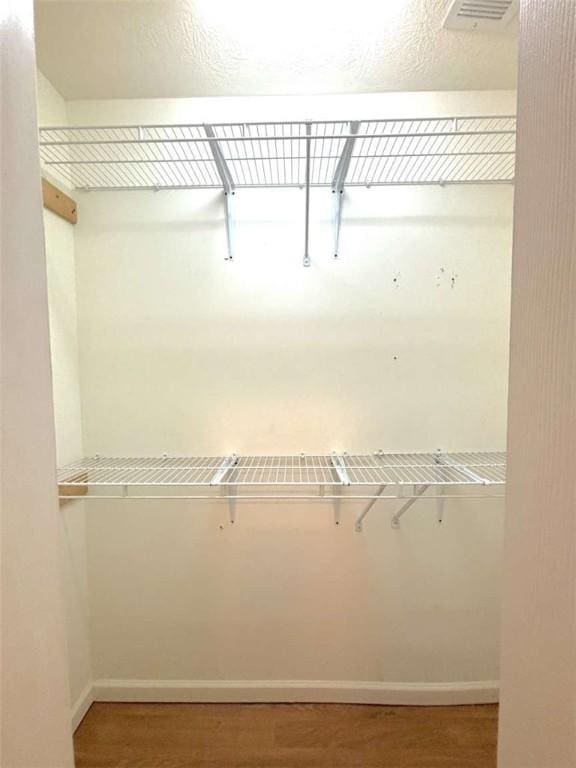 spacious closet featuring wood finished floors