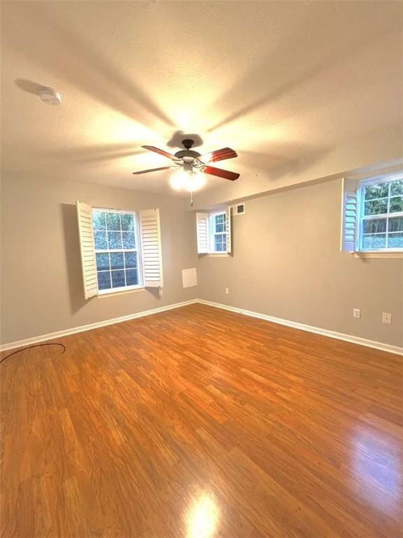 100 Westminster Dr, Ross Twp, PA 15229 - spare room with wood finished floors, ceiling fan, baseboards, and healthy amount of natural light