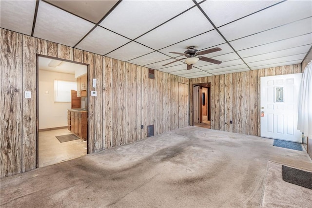 1028 Woodland Ave, Port Vue, PA 15133 - spare room with wooden walls, a paneled ceiling, ceiling fan, and carpet floors