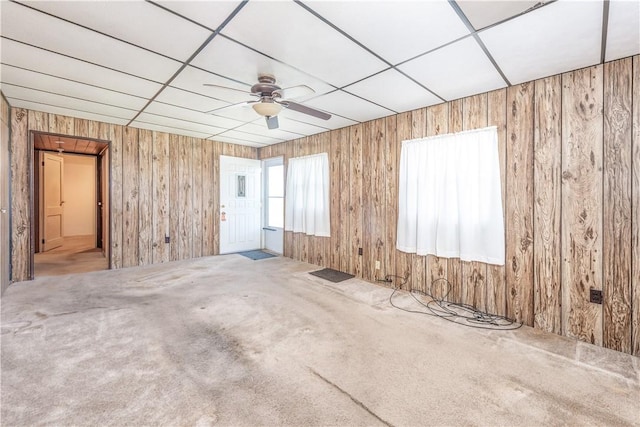 1028 Woodland Ave, Port Vue, PA 15133 - carpeted empty room featuring ceiling fan and wood walls