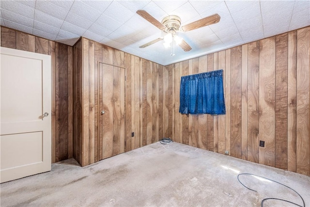 1028 Woodland Ave, Port Vue, PA 15133 - empty room featuring wooden walls, carpet floors, and a ceiling fan