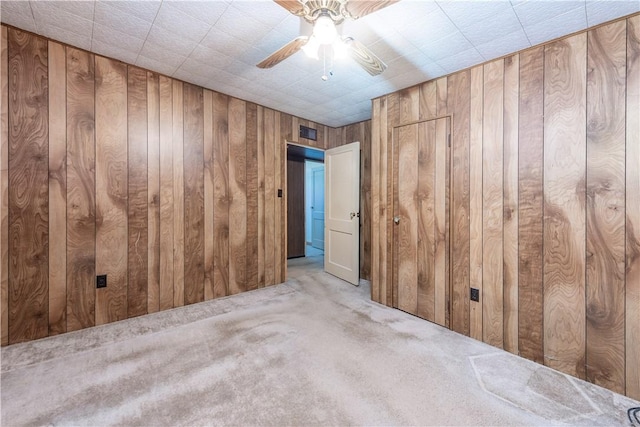 1028 Woodland Ave, Port Vue, PA 15133 - carpeted empty room featuring a ceiling fan and wood walls