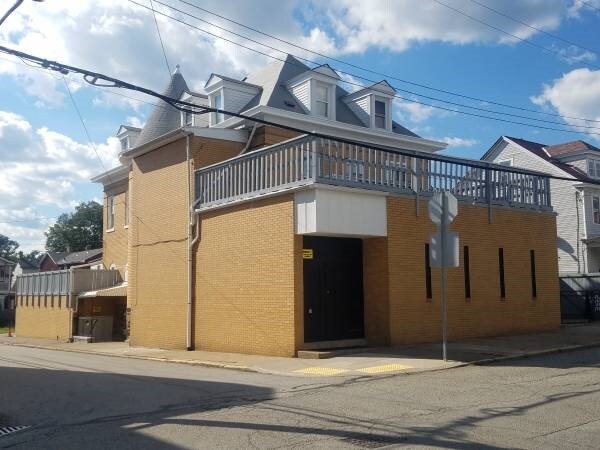 81 Allen St, Allentown, PA 15210 - view of front of home featuring brick siding and a balcony
