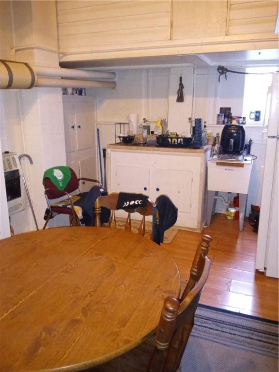 81 Allen St, Allentown, PA 15210 - dining room featuring wood finished floors and heating unit