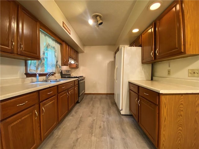1196 Rutledge Rd, Pymatuning Twp, PA 16154 - kitchen with stainless steel range with gas stovetop, a sink, light countertops, and light wood-style flooring