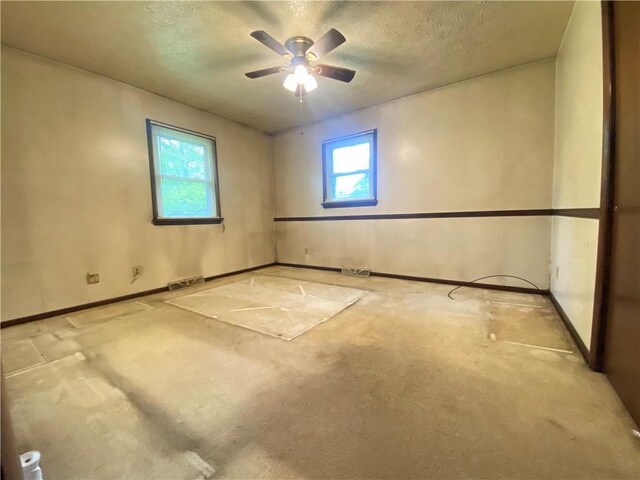 1196 Rutledge Rd, Pymatuning Twp, PA 16154 - spare room featuring light colored carpet, a textured ceiling, a ceiling fan, and baseboards