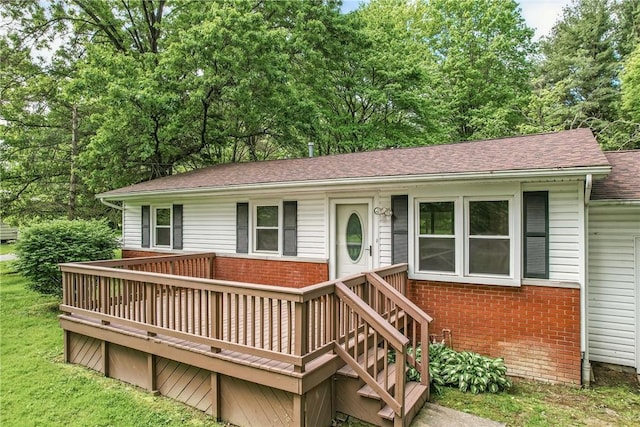1196 Rutledge Rd, Pymatuning Twp, PA 16154 - ranch-style home featuring brick siding, a shingled roof, and a wooden deck