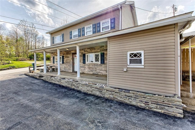 190 W Main St, Donegal Wml, PA 15628 - view of front of house featuring a porch and stone siding