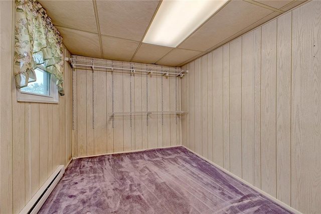 190 W Main St, Donegal Wml, PA 15628 - basement with a baseboard heating unit, carpet, wood walls, a paneled ceiling, and baseboards