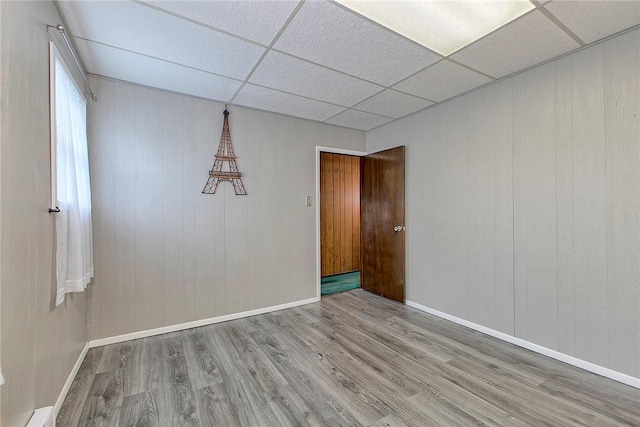 190 W Main St, Donegal Wml, PA 15628 - empty room featuring wood finished floors, a drop ceiling, and baseboards