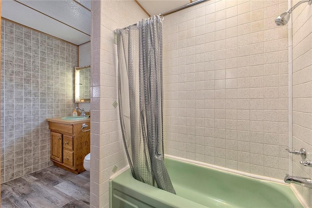 190 W Main St, Donegal Wml, PA 15628 - bathroom with wood finished floors, shower / bath combo with shower curtain, tile walls, toilet, and vanity
