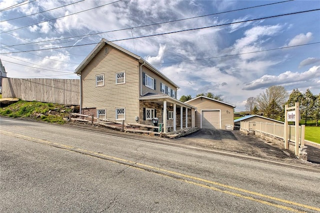 190 W Main St, Donegal Wml, PA 15628 - view of property exterior featuring fence, driveway, covered porch, and an outbuilding