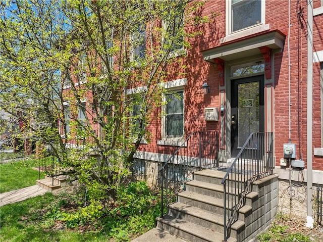 entrance to property with brick siding