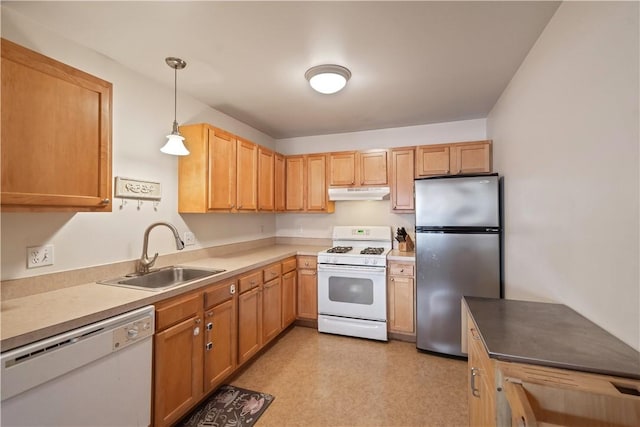 kitchen featuring white appliances, under cabinet range hood, a sink, decorative light fixtures, and light floors