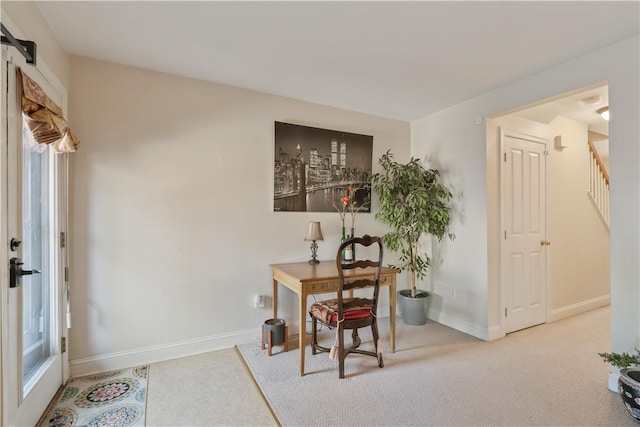 home office with baseboards, plenty of natural light, and carpet