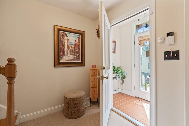 entryway with healthy amount of natural light, baseboards, and stairs