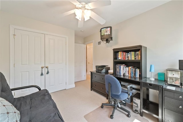 office featuring ceiling fan and light colored carpet