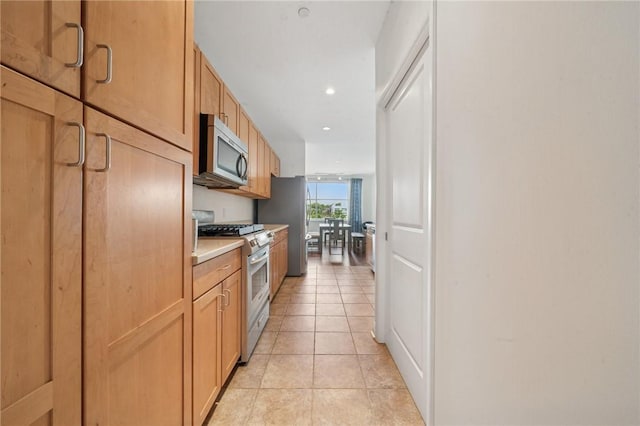 5570 Centre Ave Unit 403, Shadyside, PA 15232 - kitchen featuring stainless steel appliances, light tile patterned floors, light countertops, and recessed lighting