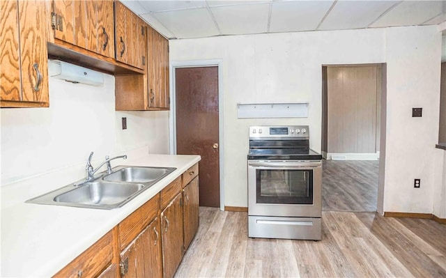 969 Water St, Indiana Boro, PA 15701 - kitchen featuring stainless steel electric stove, a sink, light wood-style flooring, brown cabinetry, and light countertops