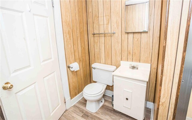 969 Water St, Indiana Boro, PA 15701 - half bath featuring toilet, wood finished floors, vanity, wooden walls, and baseboards