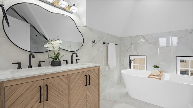 130 Prospect St, Mt Washington, PA 15211 - bathroom with marble tiled flooring, double vanity, a soaking tub, tile walls, and vaulted ceiling