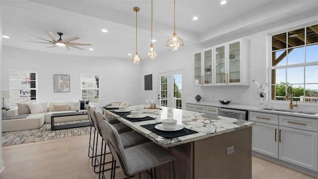 130 Prospect St, Mt Washington, PA 15211 - kitchen featuring a sink, light wood finished floors, a kitchen island, open floor plan, and french doors