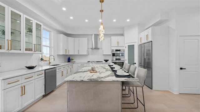 130 Prospect St, Mt Washington, PA 15211 - kitchen with appliances with stainless steel finishes, a sink, a center island, a breakfast bar area, and recessed lighting