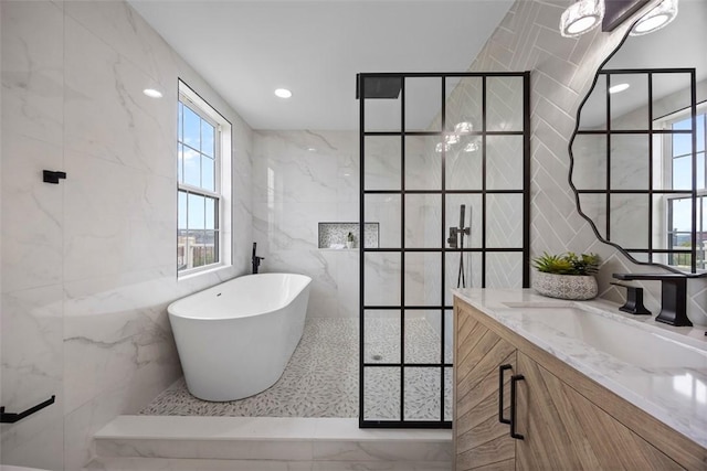 130 Prospect St, Mt Washington, PA 15211 - bathroom featuring tile walls, a soaking tub, vanity, plenty of natural light, and a tile shower