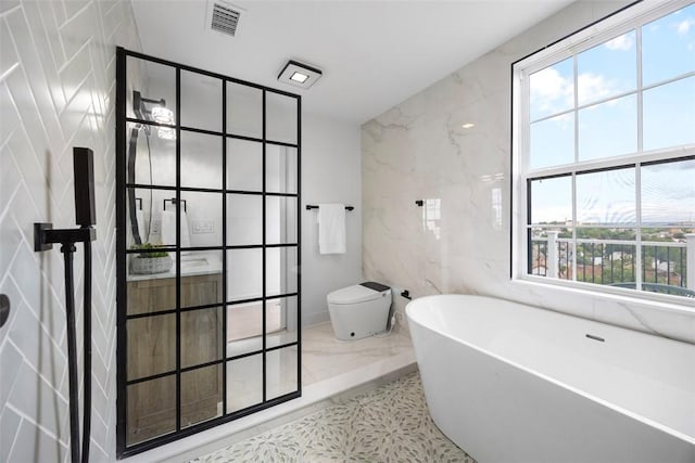 130 Prospect St, Mt Washington, PA 15211 - bathroom featuring tile walls, a soaking tub, vanity, and toilet