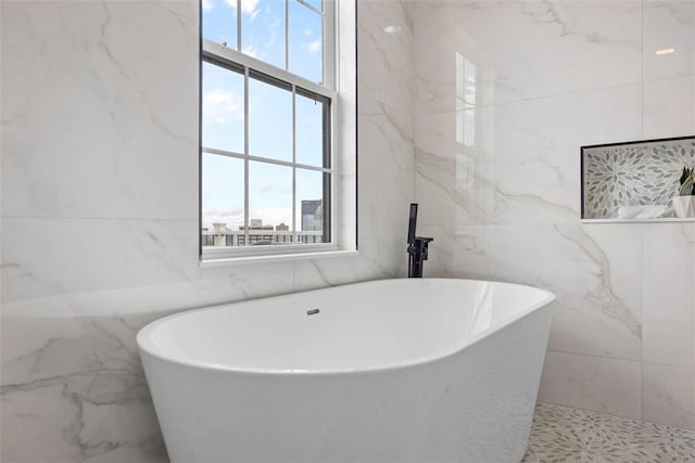 130 Prospect St, Mt Washington, PA 15211 - bathroom with tile walls, plenty of natural light, and a freestanding tub