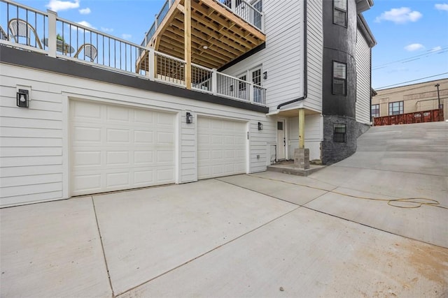 130 Prospect St, Mt Washington, PA 15211 - view of side of property featuring a balcony, concrete driveway, an attached garage, and stone siding