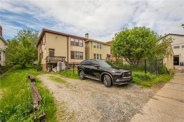 view of front of house featuring fence and stucco siding