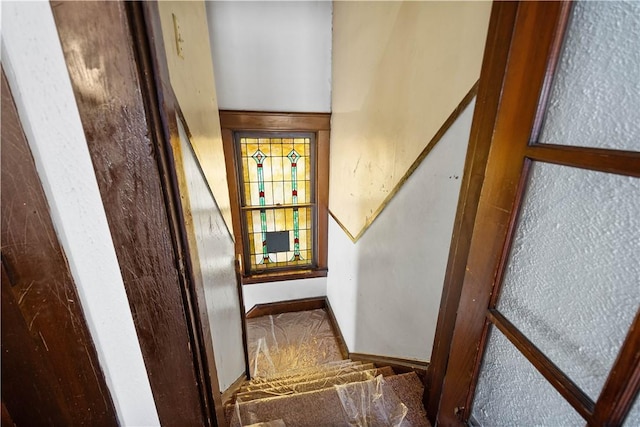 staircase with carpet flooring and baseboards