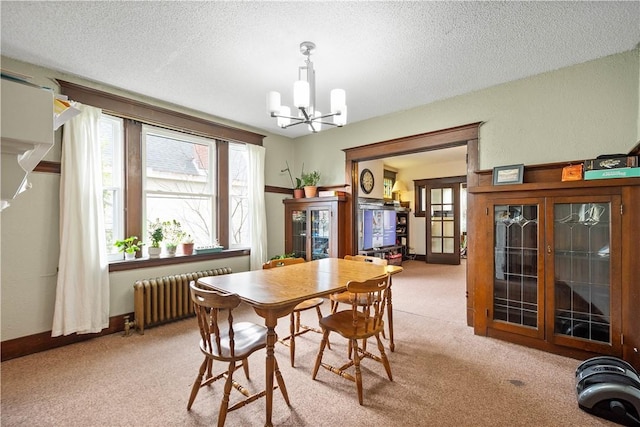 dining space with radiator, a chandelier, french doors, carpet floors, and a textured ceiling