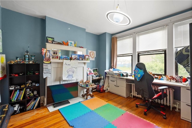 playroom featuring wood finished floors and an office area