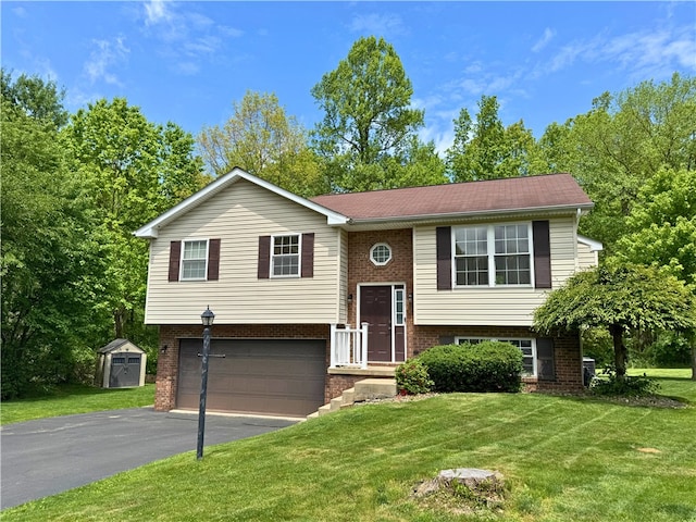 202 Jefferson Ct, Slippery Rock Boro, PA 16057 - bi-level home with brick siding, a garage, asphalt driveway, and a front yard