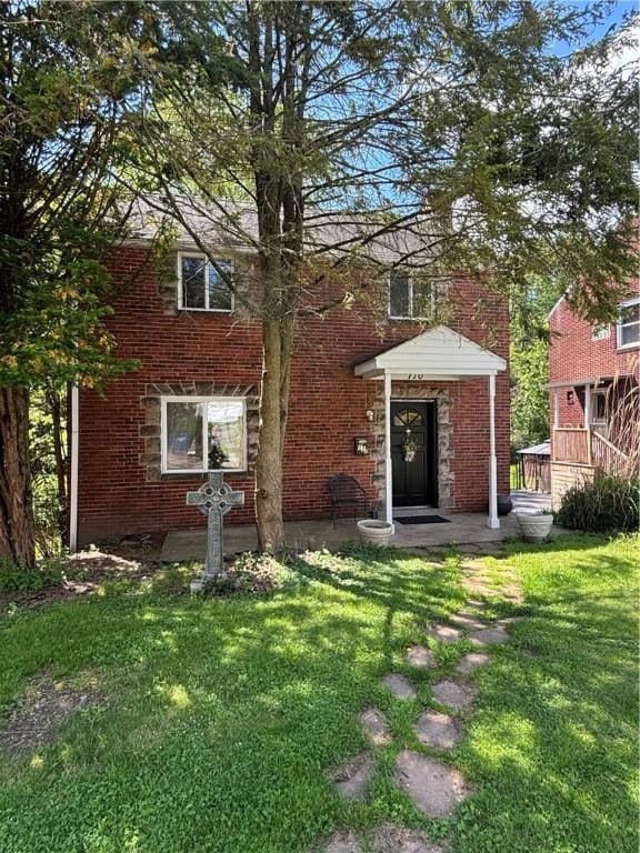 110 Orin St, Penn Hills, PA 15235 - back of house featuring a lawn and brick siding