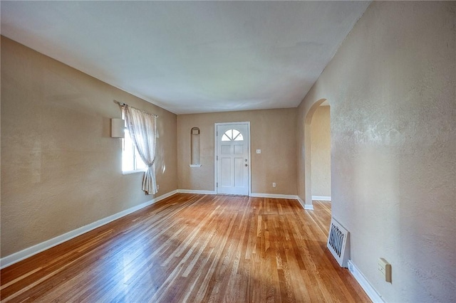 110 Orin St, Penn Hills, PA 15235 - foyer entrance featuring arched walkways, light wood-style flooring, baseboards, and a textured wall