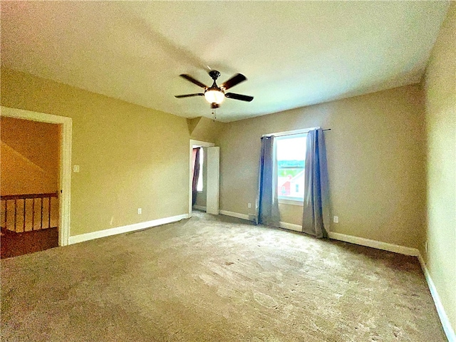 empty room featuring ceiling fan, carpet flooring, a textured ceiling, and baseboards